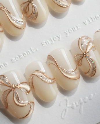 Silk Bow handmade press-on nails featuring Luxury Creamy White & Gold, 3D Champagne Gold Wire Bows & Fine Shimmer.