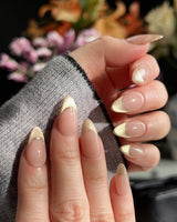 Silk Glow press-ons with luminous gold shimmer, French wire accents, and glossy gel