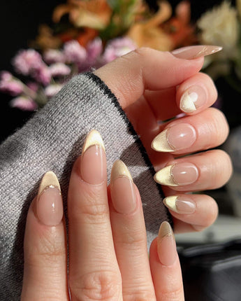 Silk Glow press-ons with luminous gold shimmer, French wire accents, and glossy gel