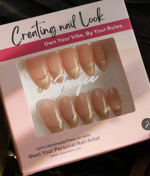 Silk Glow nail set with pale gold magnetic shine and fine metallic French linework