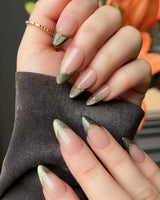 Silk Green press-on nails with dark green cat-eye French tips and delicate gold wire accents
