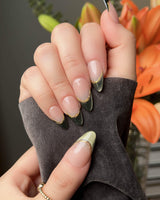Silk Green press-on nails with deep green French tips and polished gold line accents