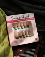 Close-up of Silk Green nails with dark cat-eye glow, French tips, and fine gold wire detail