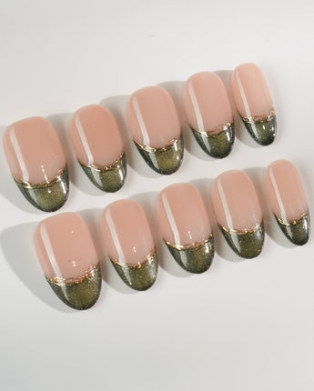 Silk Green in medium oval shape with glossy emerald French tips and fine gold accents