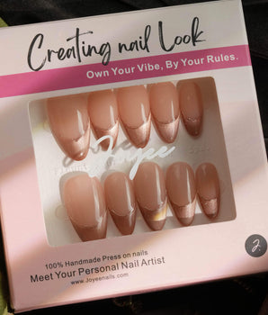 Silk Mousse nail set with soft champagne magnetic glow and delicate silver linework