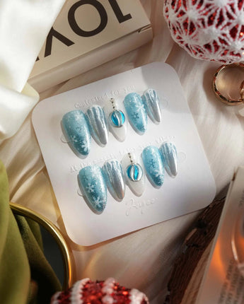 Frozen Dream press-on nail set — ice blue ombre silver chrome snowflake charm design, hand-painted with real gel polish