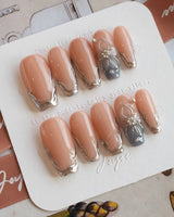 Silver Shore medium coffin nails with chrome silver tips and 3D metallic floral accent