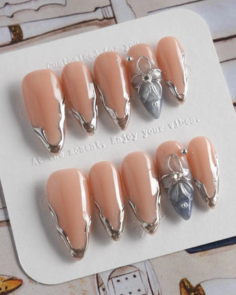 Silver Shore medium stiletto nails with nude silver chrome and 3D metallic flower