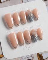 Silver Shore short almond nails with silver sculpted French tips and modern nude base