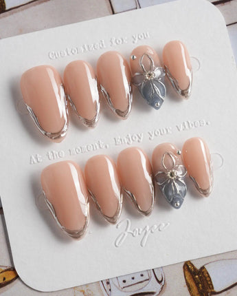 Silver Shore short almond nails with silver sculpted French tips and modern nude base
