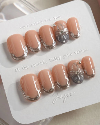 Silver Shore short oval nails with sculpted silver edges and subtle luxury finish