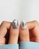 Silver Spoon chrome press-on nails with cool grey marble and scattered silver charms