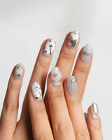 Silver Spoon short oval nails with grey marble base and liquid chrome spoon charm