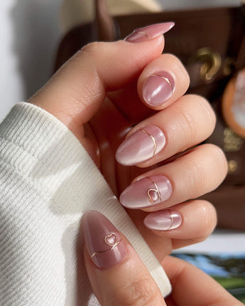 Simple love handmade press-on nails featuring Gentle Blush Cat Eye, Simple Gold Lines & 3D Hearts.