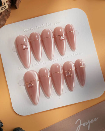 Simple love press-on nails in medium stiletto shape — Gentle Blush Cat Eye, Simple Gold Lines & 3D Hearts.