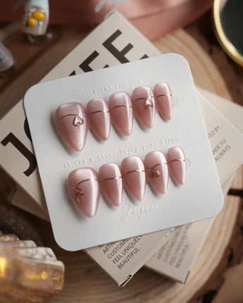 Simple love press-on nails in short stiletto shape — Gentle Blush Cat Eye, Simple Gold Lines & 3D Hearts.