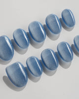 Sky Cat-eye press-on nails in extra short oval shape — blue cat eye nails