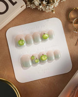 Slushie Apple close-up of 3D green apples on icy blue cat-eye press-on nails