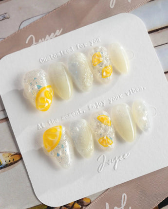Slushie Lemon glossy summer nails with frozen white shimmer and citrus slice details