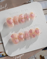 Slushie Peach close-up of peach ombre nail art with fruit charms and water drops