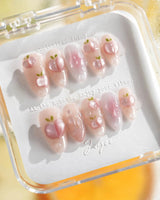 Slushie Peach short almond nail set with juicy peach slices and soft pink shimmer