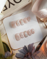 Snowfall press-on nails — pearl nude cat eye snowflake bow silver glitter soft sheen handmade nail art by Joyee Nails