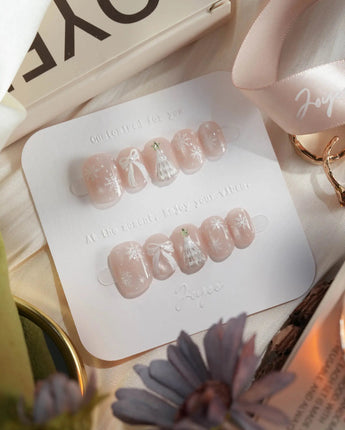 Snowfall press-on nails — pearl nude cat eye snowflake bow silver glitter soft sheen handmade nail art by Joyee Nails