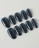 Glitter Glitz Navy press-on nails in medium oval shape — deep blue cat eye glitter nails
