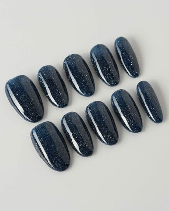 Glitter Glitz Navy press-on nails in medium oval shape — deep blue cat eye glitter nails