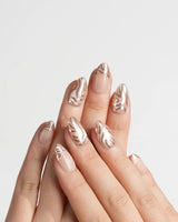 Solar Cycle handmade press-on nails featuring Icy Nude Pink & Rose Gold, 3D Mirror Streamlined Textures & French Tip Accents.