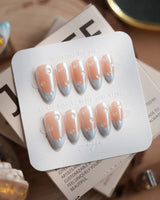 Sparkling Wine short almond press-on nails with blue chrome French tips
