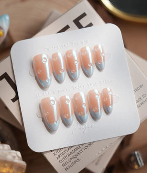 Sparkling Wine handmade press-on nails featuring blue chrome french tip nails