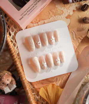 Spiral Twist nail set with pearl nude base, silk-like texture, and daisy nail art