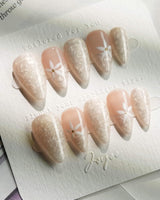Spiral Twist in short stiletto shape with pearly nude shimmer and daisy details