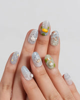 Splash Club close-up of swirly blue and mint pool nail art with floating bubbles