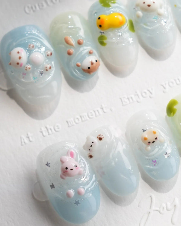 Splash Club short oval nails with 3D pool animals, blue water ripples, stars, and daisies