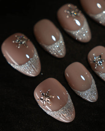 Spotlight Muse handmade press-on nails featuring Soft Nude Pink, Silver Glitter French Gradients & 3D Crystal Ice Accents.