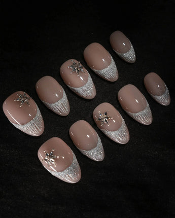 Spotlight Muse nail art close-up showing Soft Nude Pink, Silver Glitter French Gradients & 3D Crystal Ice Accents. details