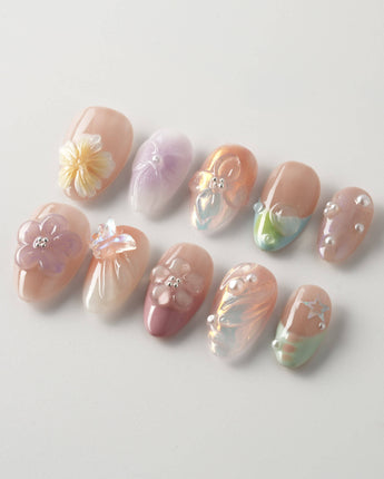 Wonderland Whims spring nails with soft pastel pink, raised flowers, and glossy pearl details