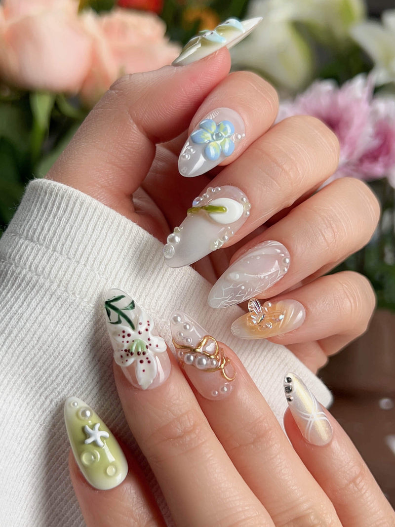 Spring Wink handmade press-on nails featuring fresh forest-inspired design with 3D sculpted lilies and butterfly accents on medium almond shape
