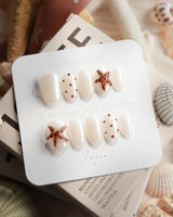 Starfish & Dots extra short oval nails with chocolate polka dots and 3D starfish