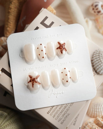 Starfish & Dots extra short oval nails with chocolate polka dots and 3D starfish
