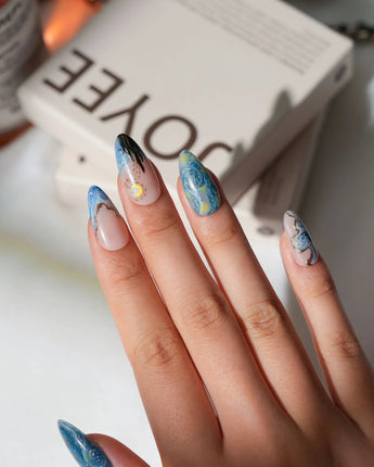Starry Night L press-on nails in medium almond with blue night sky and gold star accents