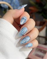 Starry River short coffin nails with river-flow blue swirls and soft white marble