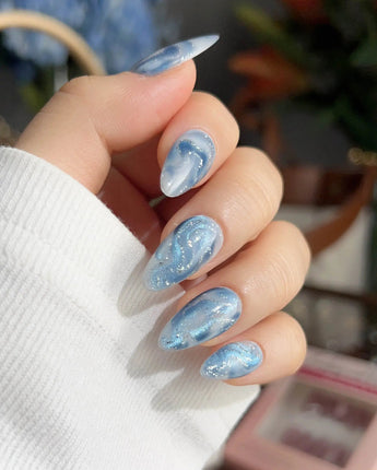 Starry River short coffin nails with river-flow blue swirls and soft white marble