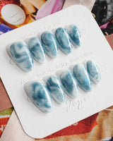 Starry River handmade press-ons with calm blue marble pattern and watery cat-eye glow