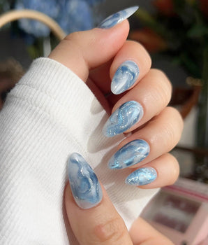 Starry River flowing river nails with aqua blue marble, white swirls, and silver shimmer