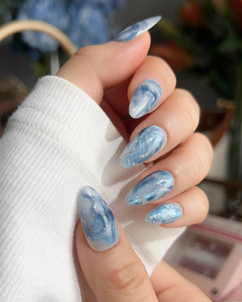 Starry River flowing river nails with aqua blue marble, white swirls, and silver shimmer
