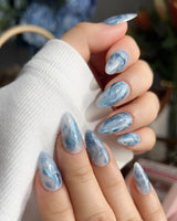 Starry River tranquil summer nails with fluid marble currents and glossy aqua finish