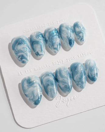 Starry River extra short almond nails with aqua marble swirls and silver shimmer